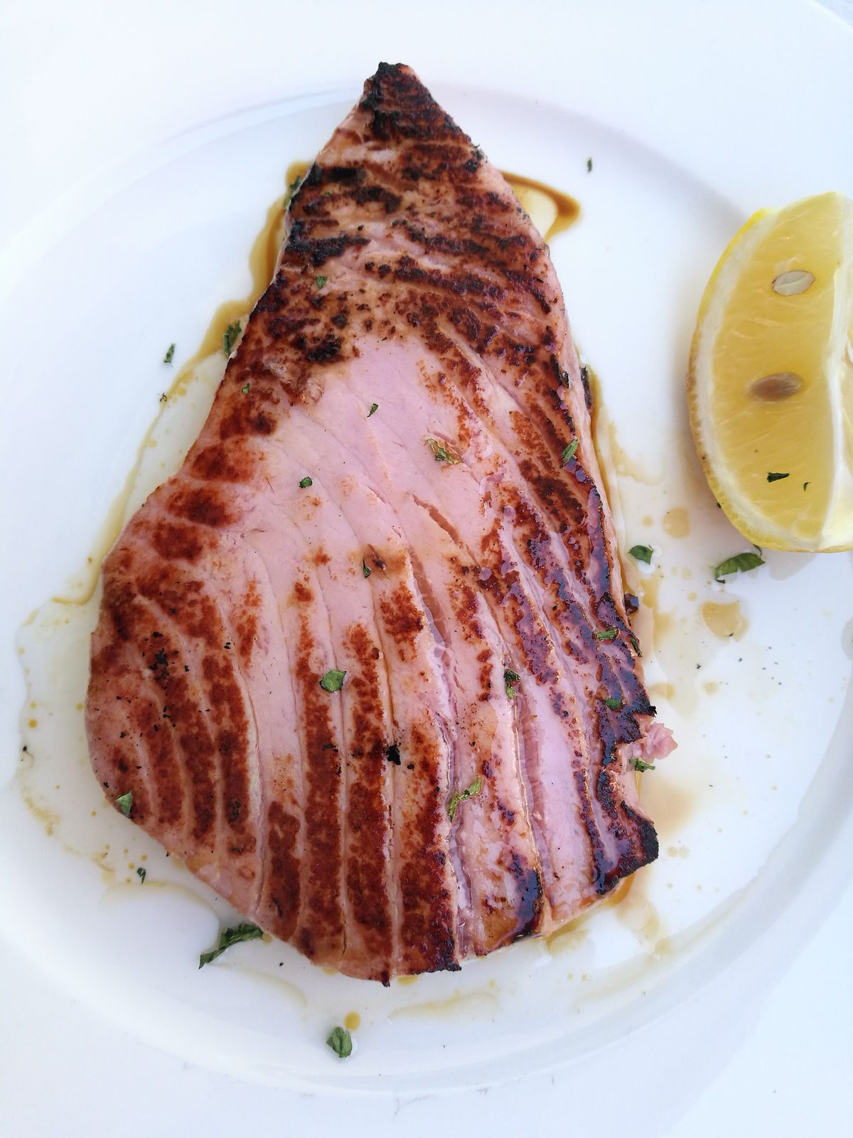 Seared yellowfin tuna steak served with lemon